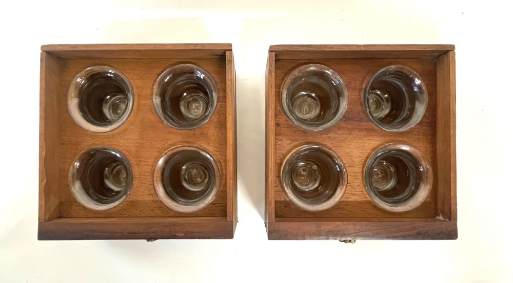 A Georgian dark mahogany apothecary chest with an open hinged lid revealing glass stoppered bottles, a side-hinged door, and interior drawers with brass handles. View XVII