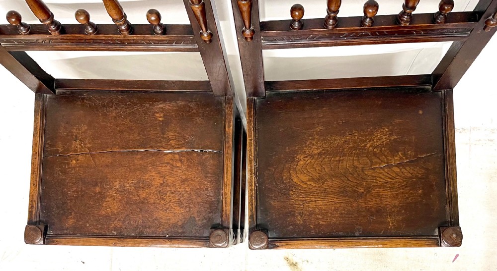 Set of four dark oak dining chairs featuring arcaded carved backs with turned spindles, scroll crestings, and solid plank seats. View XIII