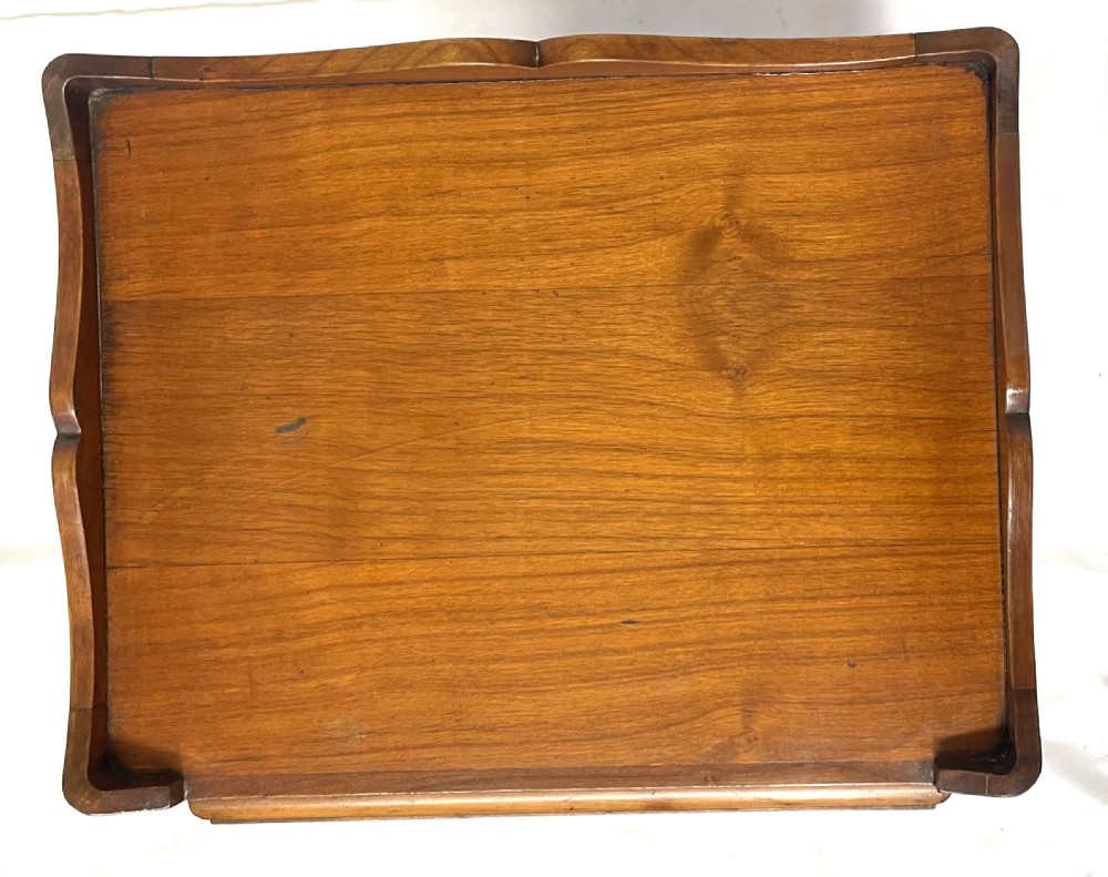 A pair of French satin walnut bedside cabinets featuring three drawers with brass handles, carved shell details on the apron, and slender cabriole legs. View XIV
