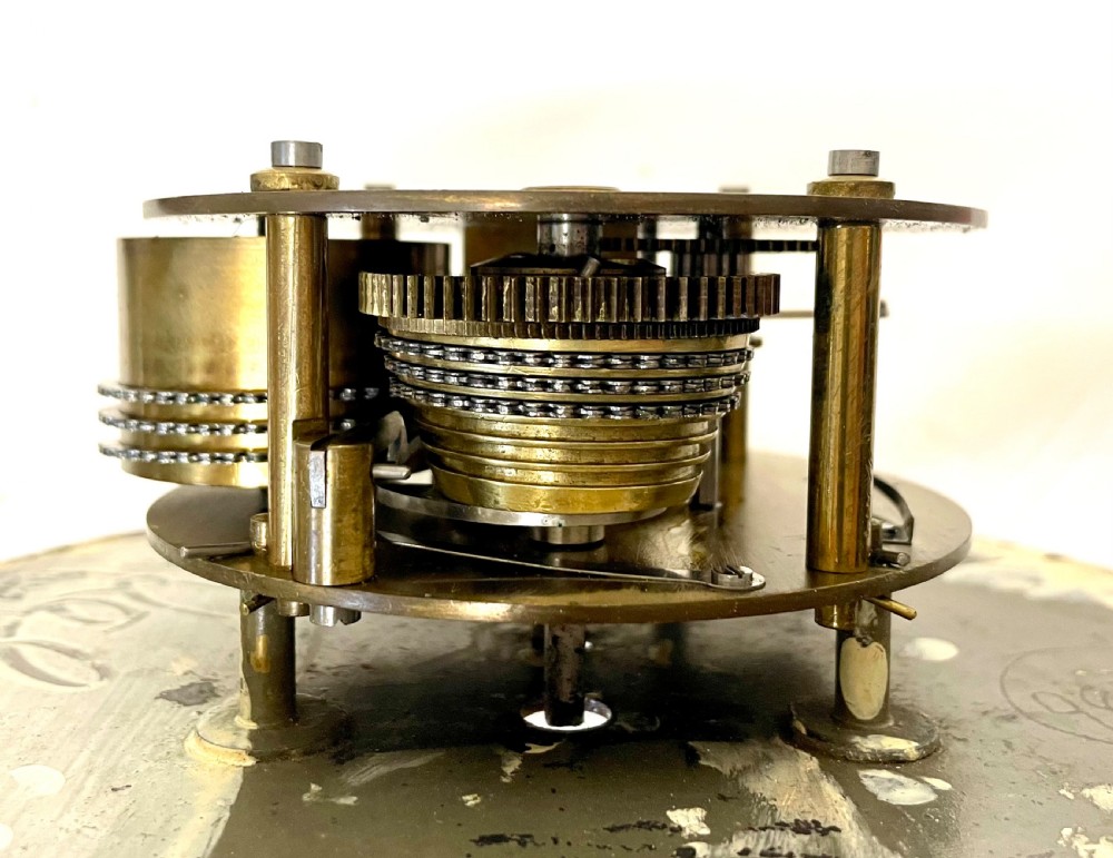An antique circular nickel-plated brass ships bulkhead clock featuring a cream dial with Roman numerals and a subsidiary seconds dial. View XII