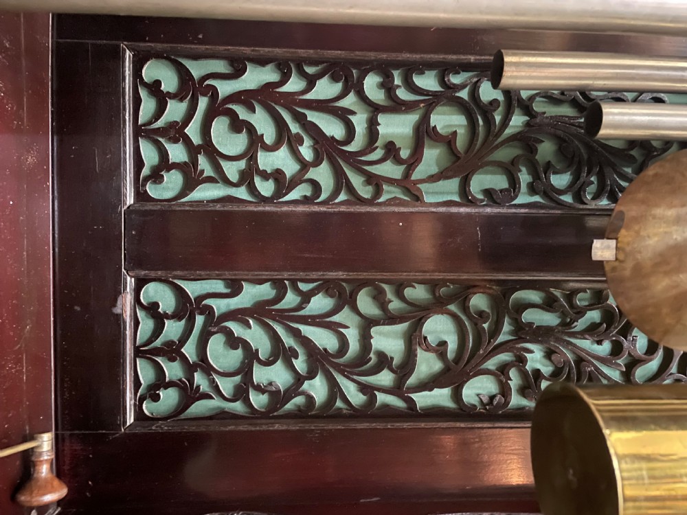 An antique Chippendale Revival mahogany longcase clock featuring a carved swan-neck pediment, floral marquetry, and a brass dial behind a glazed door. View XIII