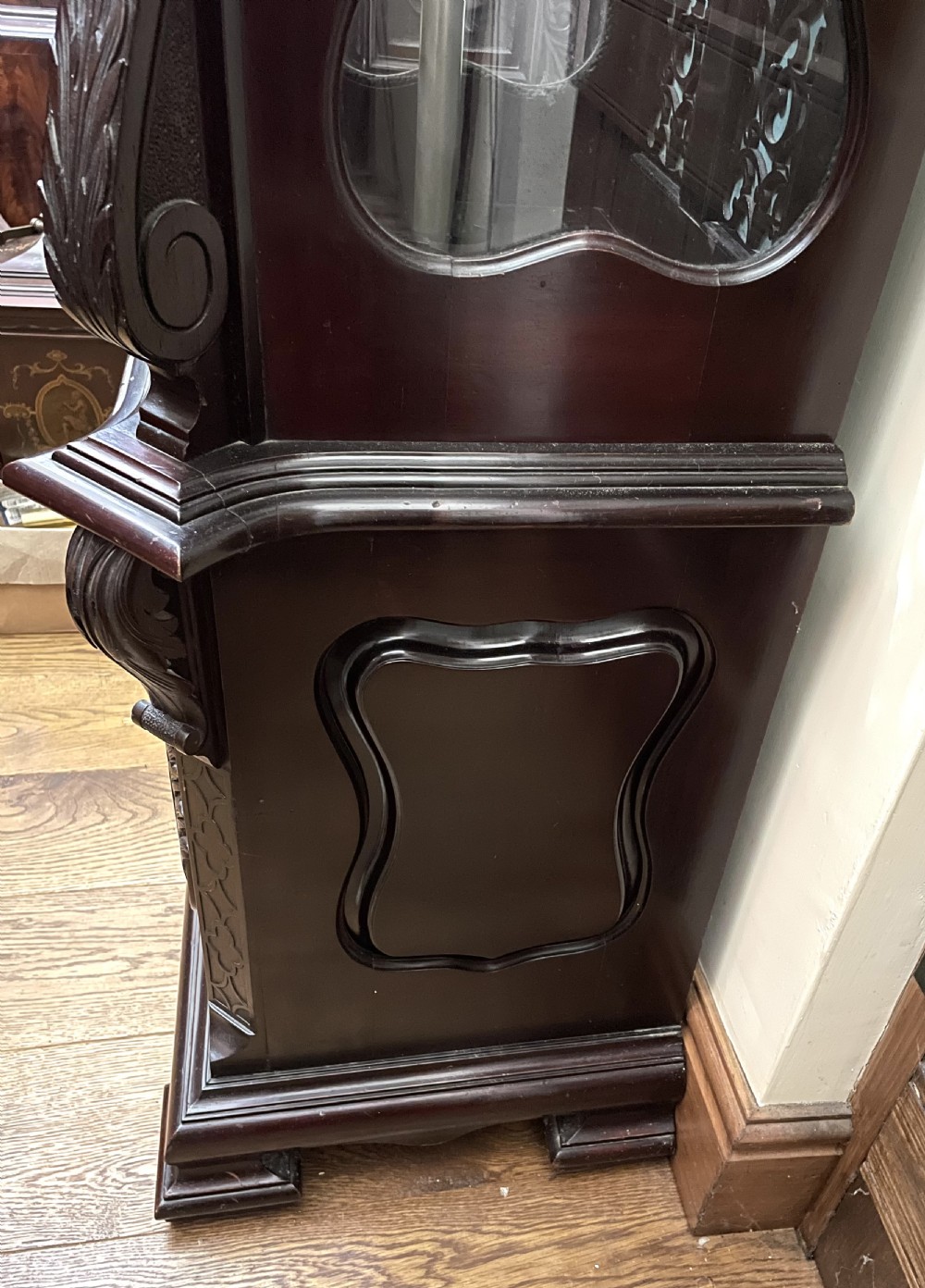 An antique Chippendale Revival mahogany longcase clock featuring a carved swan-neck pediment, floral marquetry, and a brass dial behind a glazed door. View XIV
