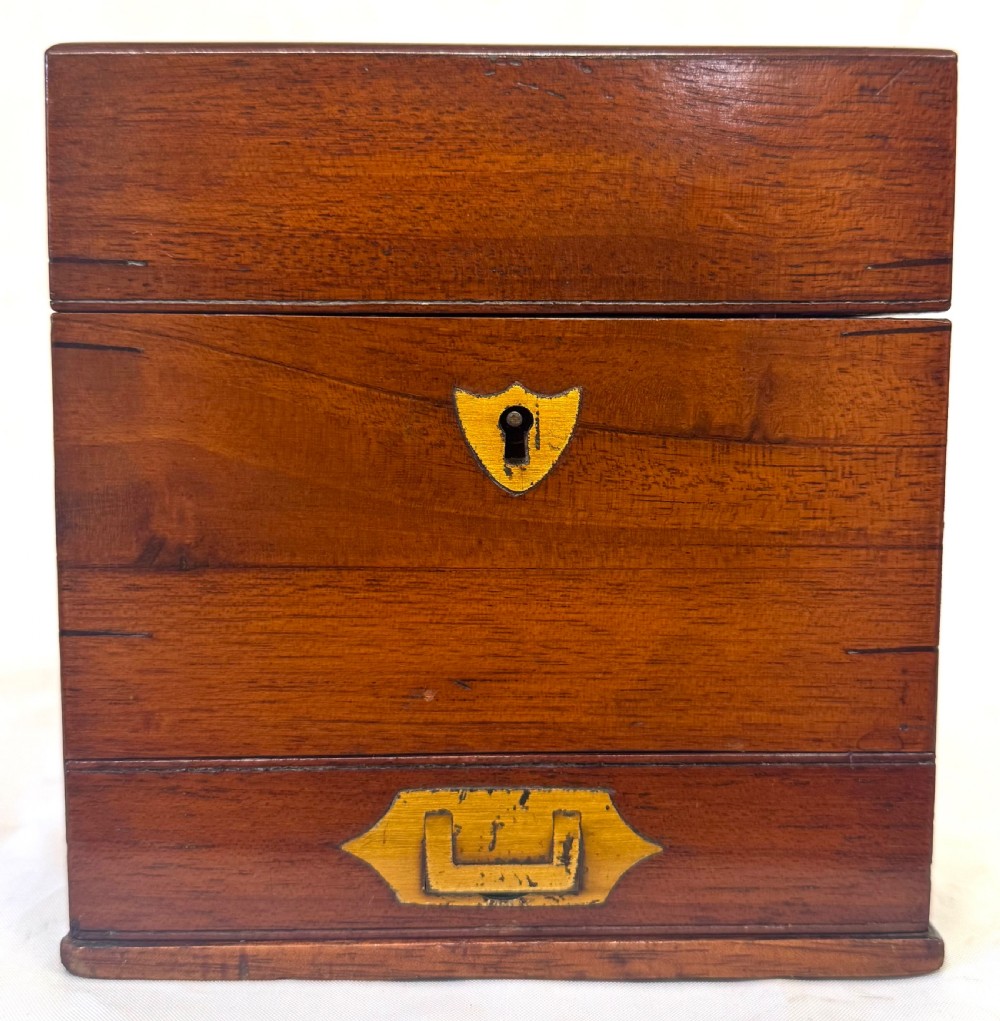 An antique wooden apothecary box shown open with glass stoppered bottles in top compartments and labelled vials in a velvet-lined lower drawer. View IX