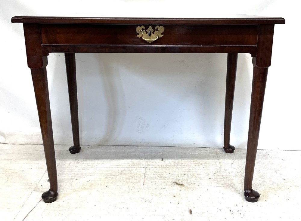 An antique Georgian mahogany side table featuring a rectangular top with a moulded rim, a single drawer with brass hardware, and slender cabriole legs ending in pad feet. View V