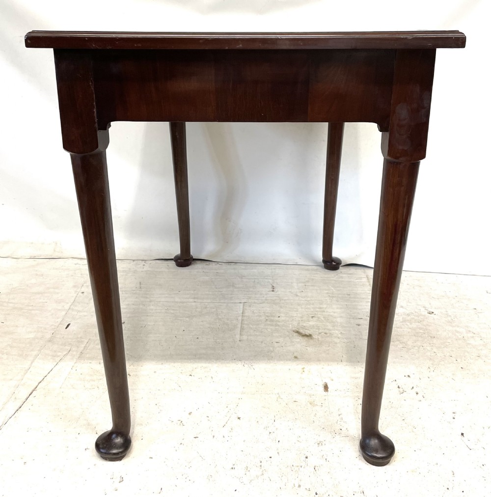 An antique Georgian mahogany side table featuring a rectangular top with a moulded rim, a single drawer with brass hardware, and slender cabriole legs ending in pad feet. View IX