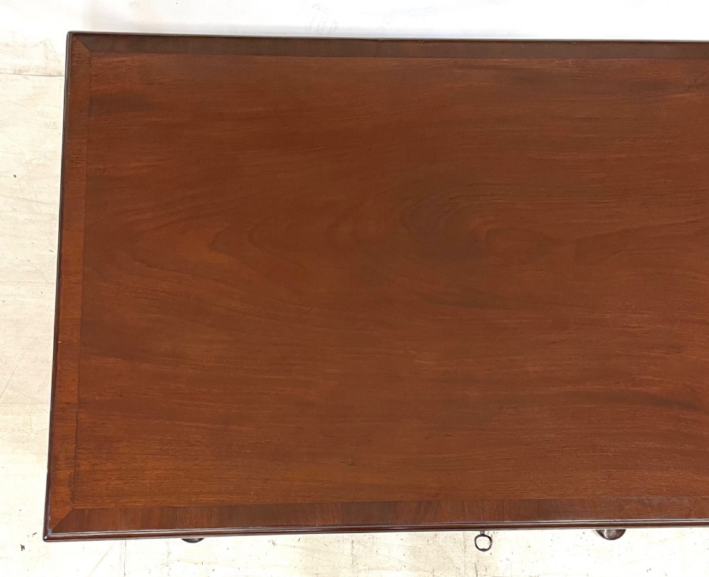 An antique Georgian mahogany side table featuring a rectangular top with a moulded rim, a single drawer with brass hardware, and slender cabriole legs ending in pad feet. View XII