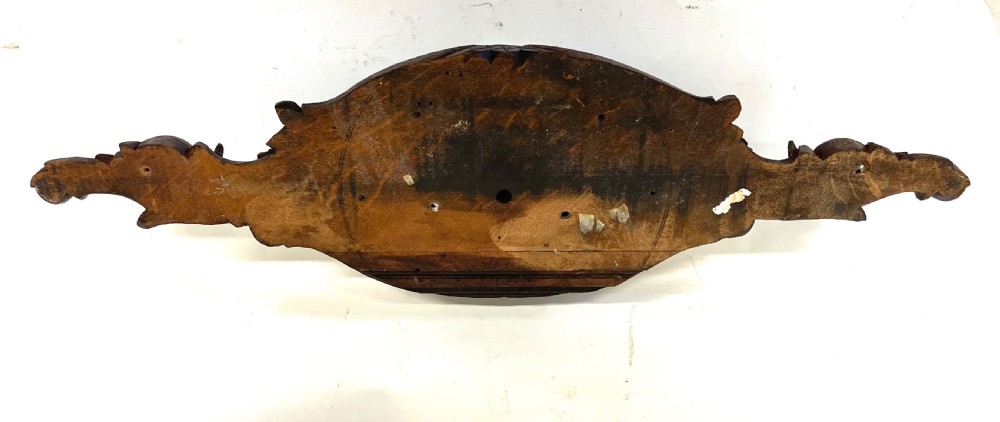 A horizontally orientated Victorian carved oak aneroid barometer featuring a central circular brass dial flanked by carved leaf motifs and bird figures. View XVIII