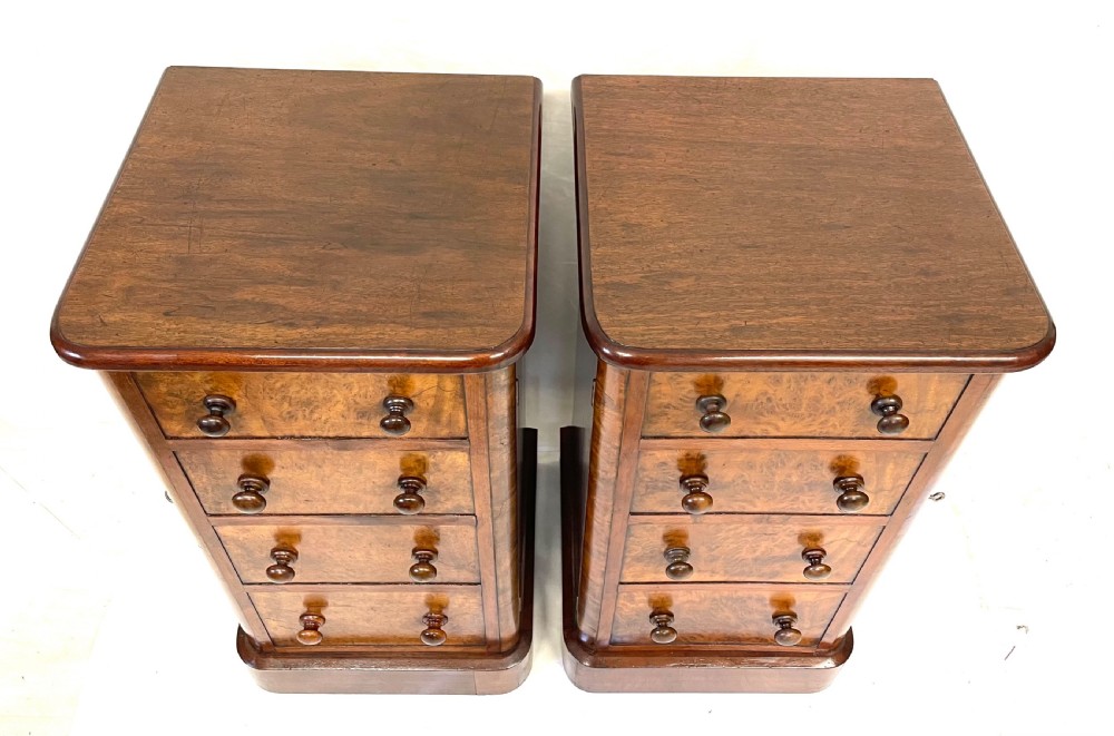 A pair of narrow Victorian burr walnut bedside cabinets featuring four drawers each, turned wooden handles, side locking mechanisms, and plinth bases. View XII