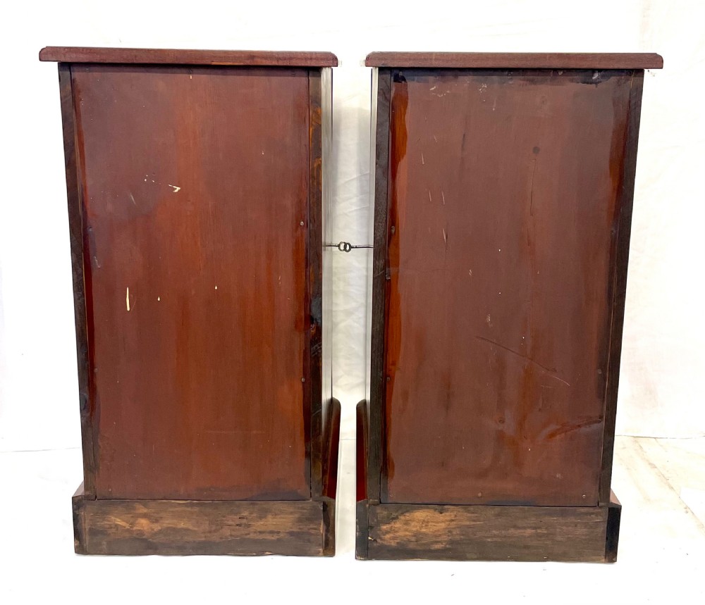 A pair of narrow Victorian burr walnut bedside cabinets featuring four drawers each, turned wooden handles, side locking mechanisms, and plinth bases. View XVII