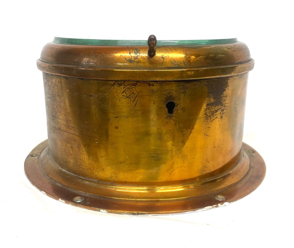 A circular brass-cased ship clock with a white dial displaying black Roman numerals, spade hands, and the maker name Prescot Clock Co. View IX