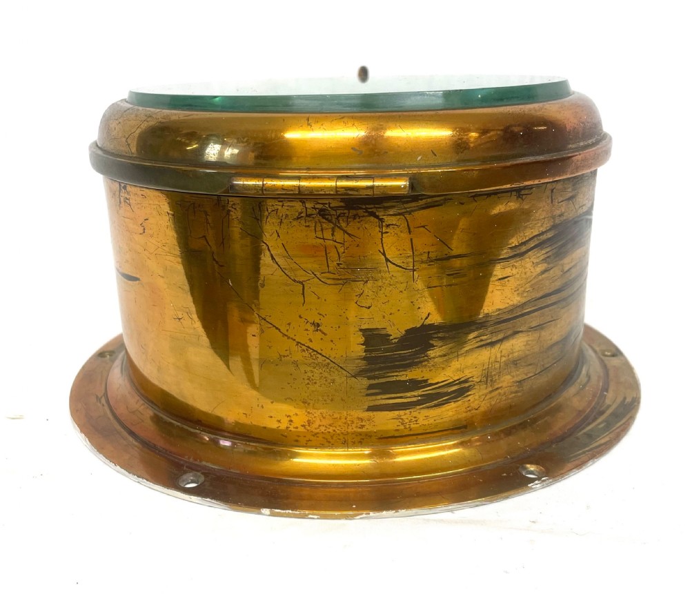 A circular brass-cased ship clock with a white dial displaying black Roman numerals, spade hands, and the maker name Prescot Clock Co. View XI