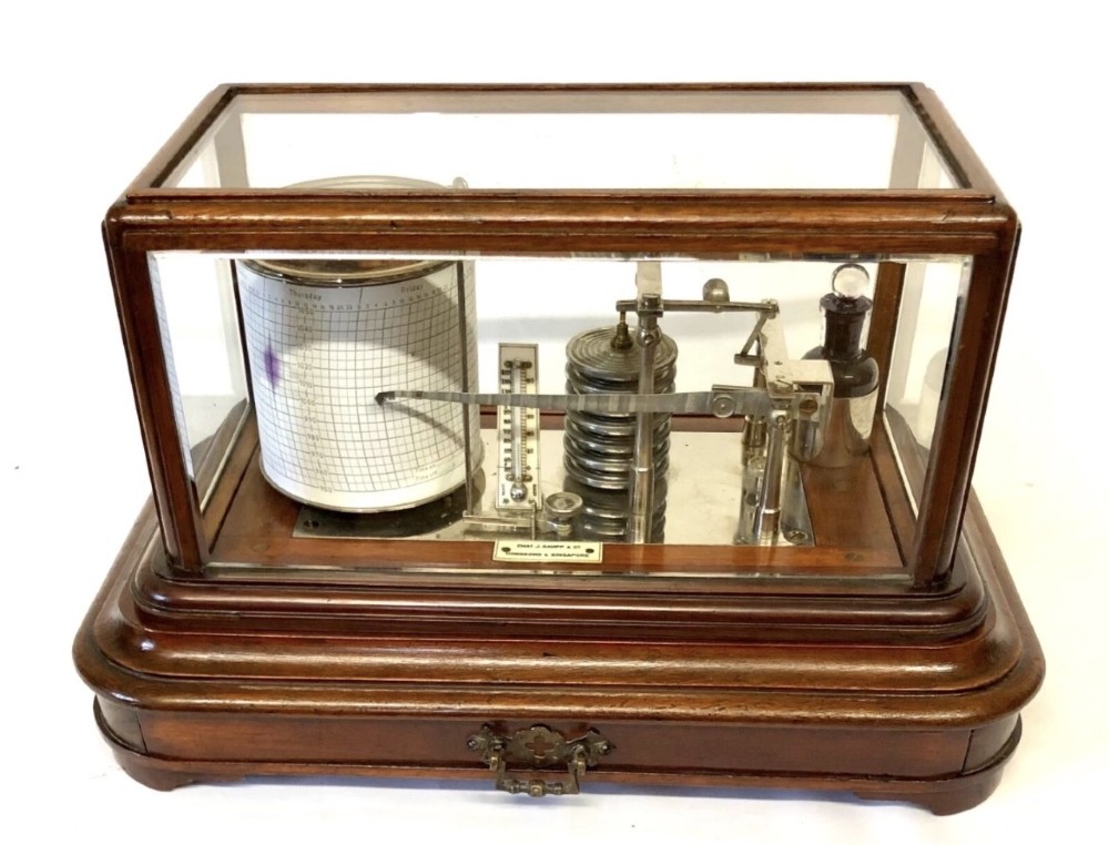 An antique mahogany and glass-cased recording barograph showing internal mechanical brass drums, aneroid pressure cells, and an integrated thermometer above a base drawer. View II