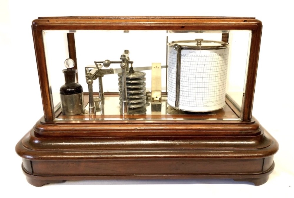 An antique mahogany and glass-cased recording barograph showing internal mechanical brass drums, aneroid pressure cells, and an integrated thermometer above a base drawer. View V
