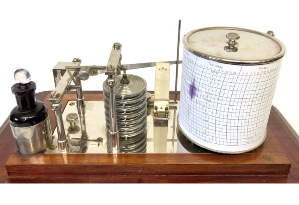 An antique mahogany and glass-cased recording barograph showing internal mechanical brass drums, aneroid pressure cells, and an integrated thermometer above a base drawer. View XI