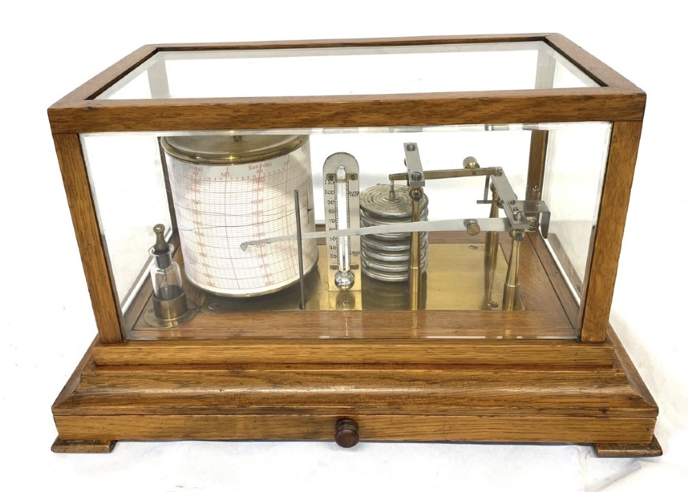 An antique barograph featuring brass recording mechanisms and a paper chart drum enclosed in a glazed oak case with a bottom chart drawer. View II