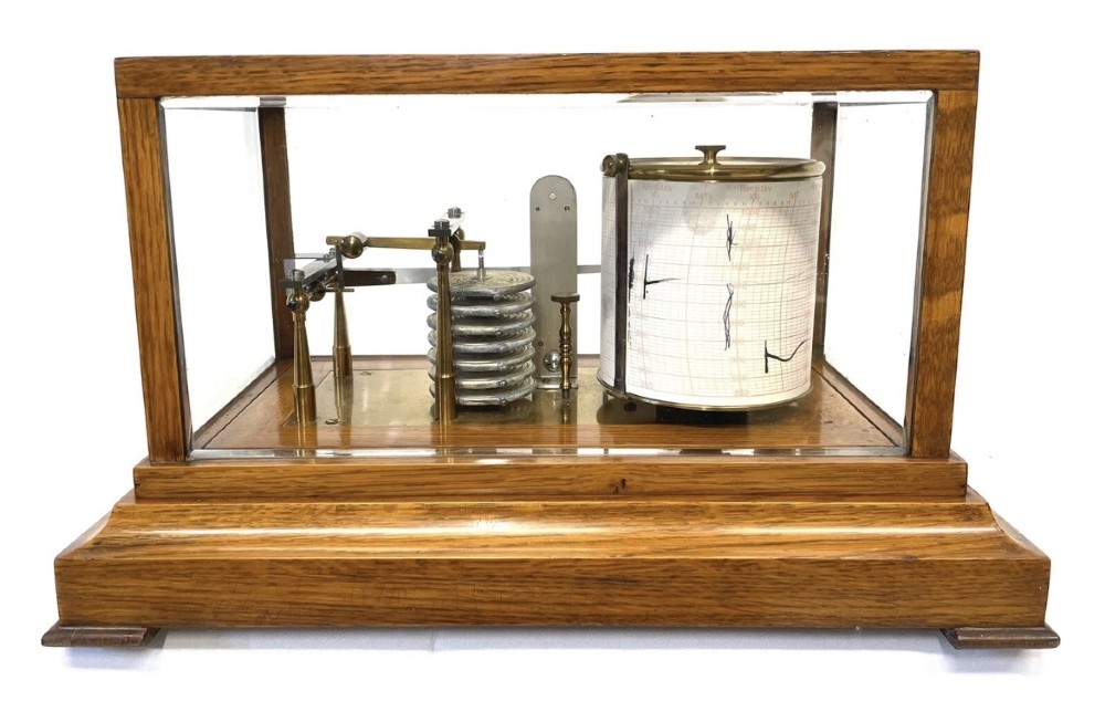 An antique barograph featuring brass recording mechanisms and a paper chart drum enclosed in a glazed oak case with a bottom chart drawer. View VIII