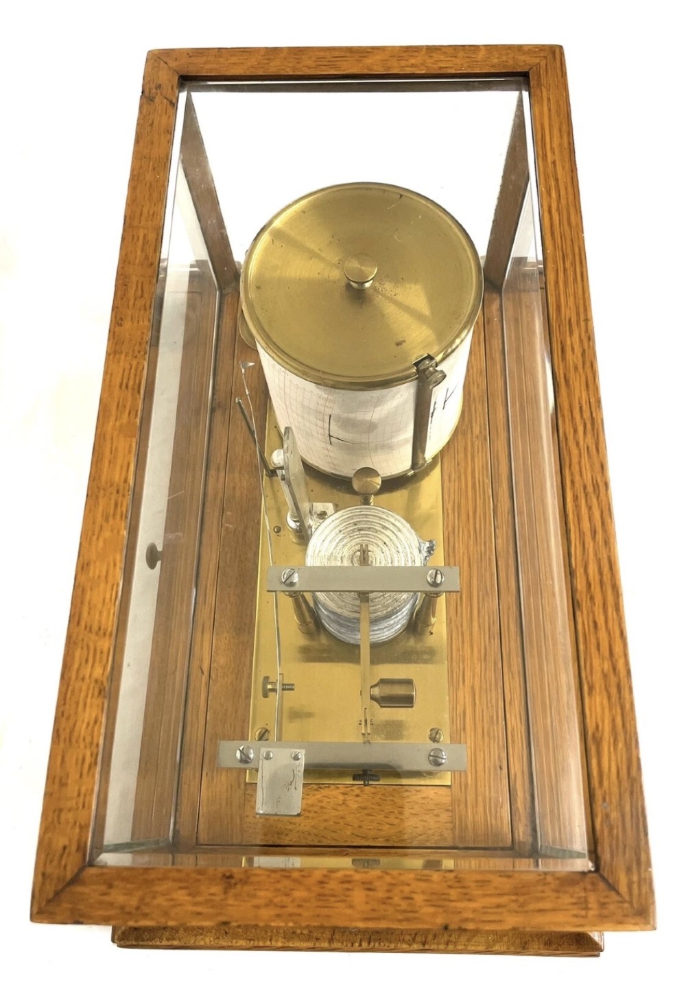 An antique barograph featuring brass recording mechanisms and a paper chart drum enclosed in a glazed oak case with a bottom chart drawer. View IX