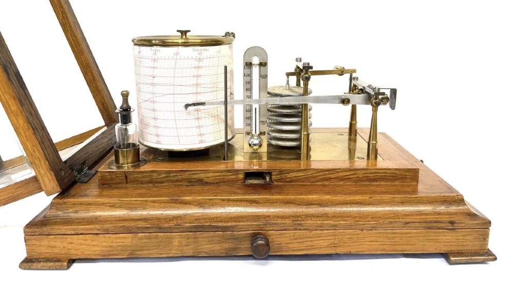 An antique barograph featuring brass recording mechanisms and a paper chart drum enclosed in a glazed oak case with a bottom chart drawer. View XIII