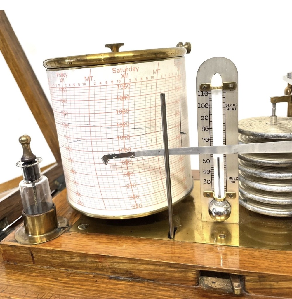 An antique barograph featuring brass recording mechanisms and a paper chart drum enclosed in a glazed oak case with a bottom chart drawer. View XIV
