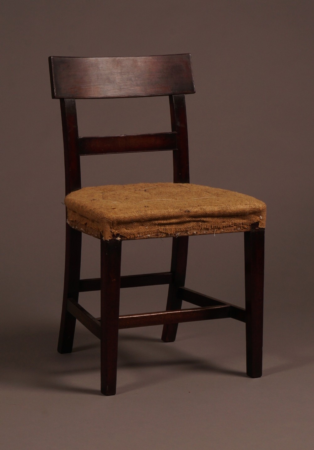 A set of ten George III mahogany dining chairs featuring horizontal bar backrests and hessian-padded drop-in seats. View II