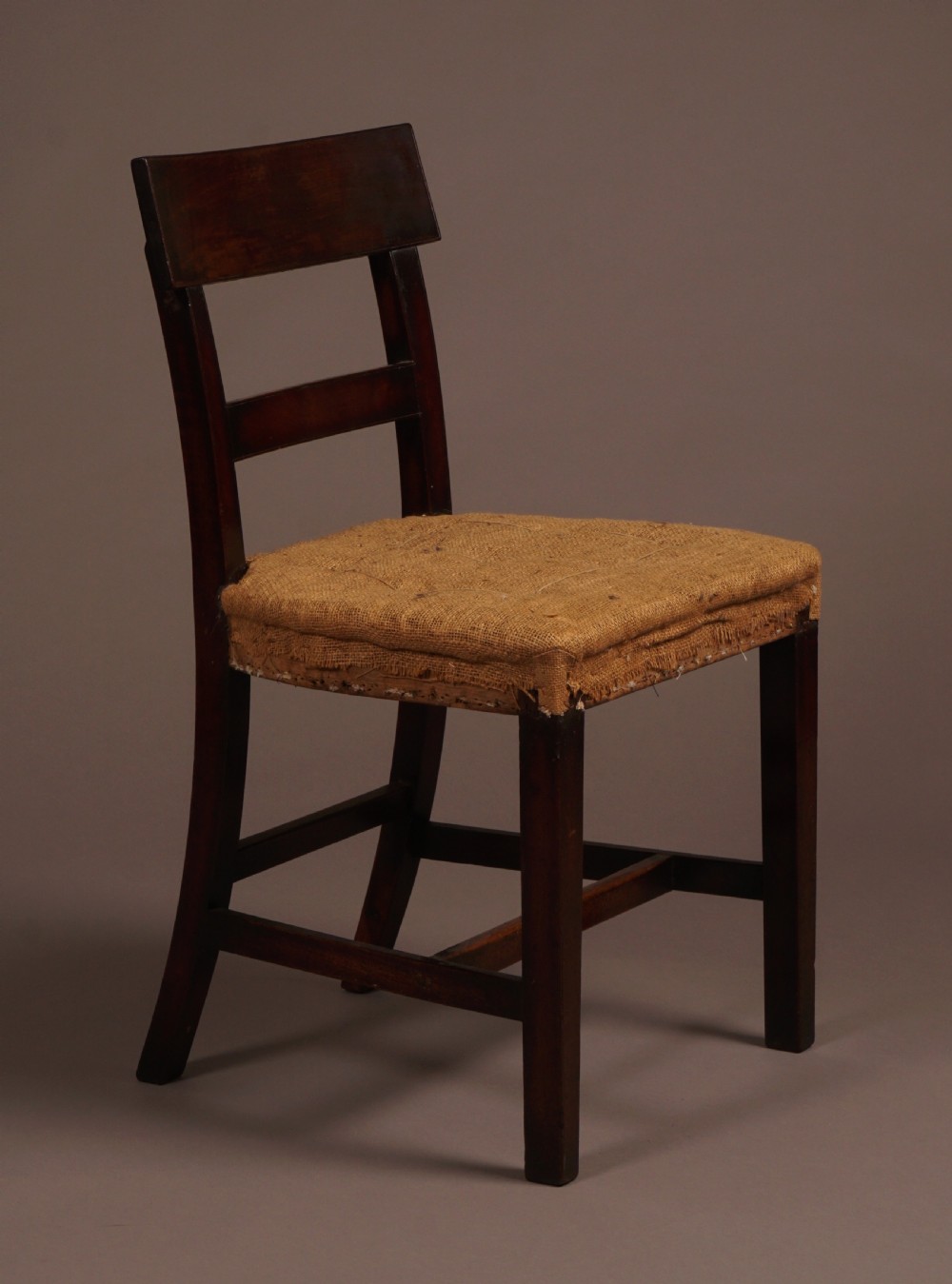 A set of ten George III mahogany dining chairs featuring horizontal bar backrests and hessian-padded drop-in seats. View III