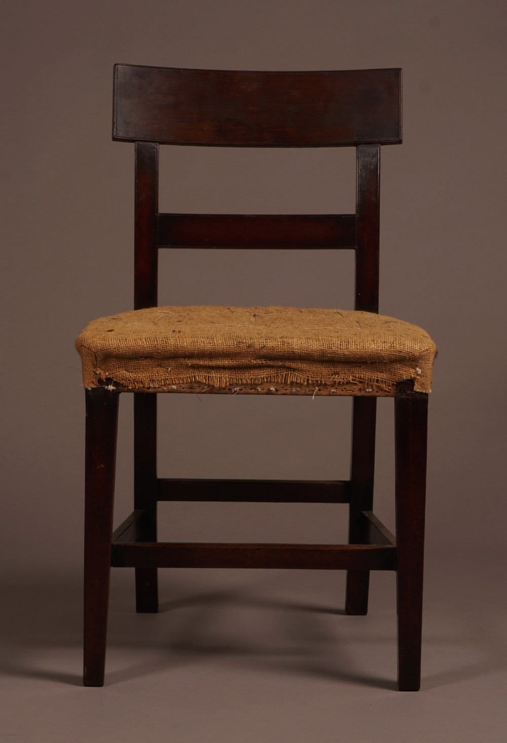 A set of ten George III mahogany dining chairs featuring horizontal bar backrests and hessian-padded drop-in seats. View IV