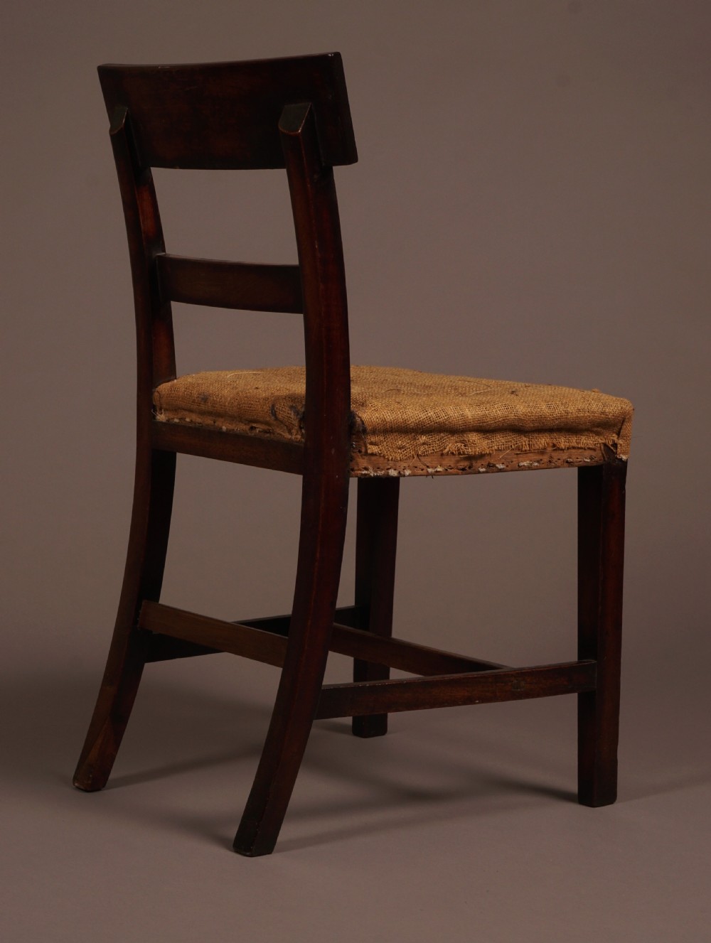 A set of ten George III mahogany dining chairs featuring horizontal bar backrests and hessian-padded drop-in seats. View VI