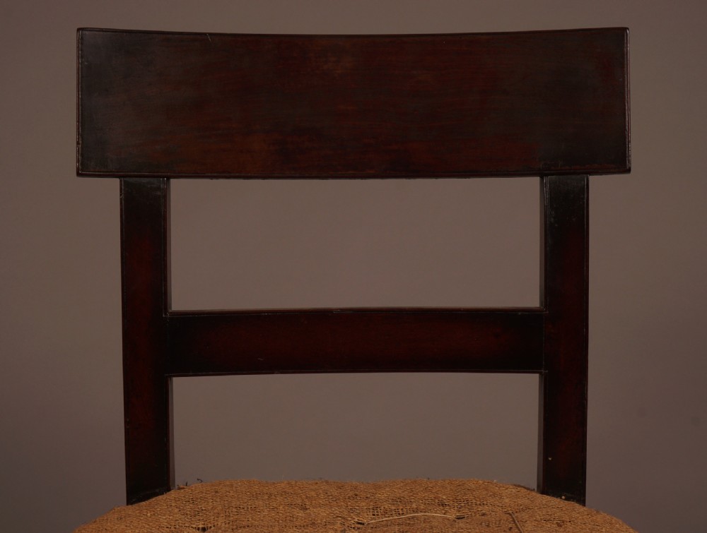 A set of ten George III mahogany dining chairs featuring horizontal bar backrests and hessian-padded drop-in seats. View VII