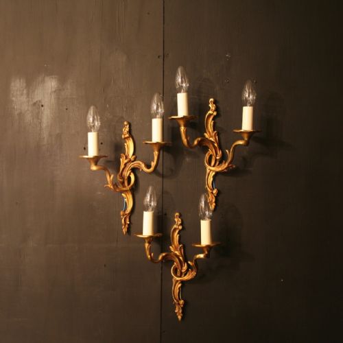 A French Set of Three Bronze Twin Arm Antique Wall Lights