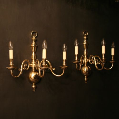 A Flemish Pair of Brass Triple Arm Wall Lights