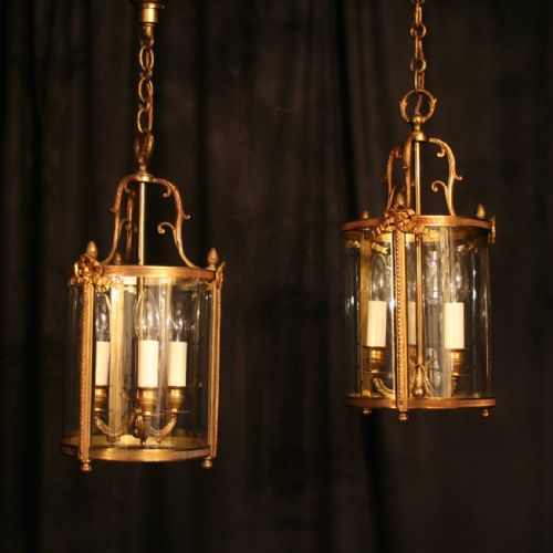 A French Pair of Gilded Bronze Triple Light Convex Hall Lanterns