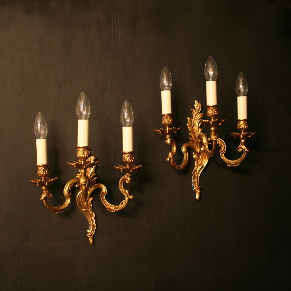 A French Pair Of Gilded Triple Arm Wall Lights