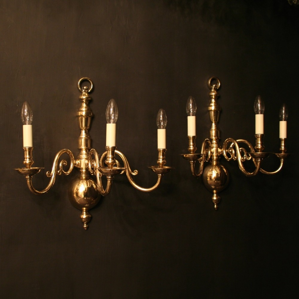 A Flemish Pair Of Brass Triple Arm Wall Lights