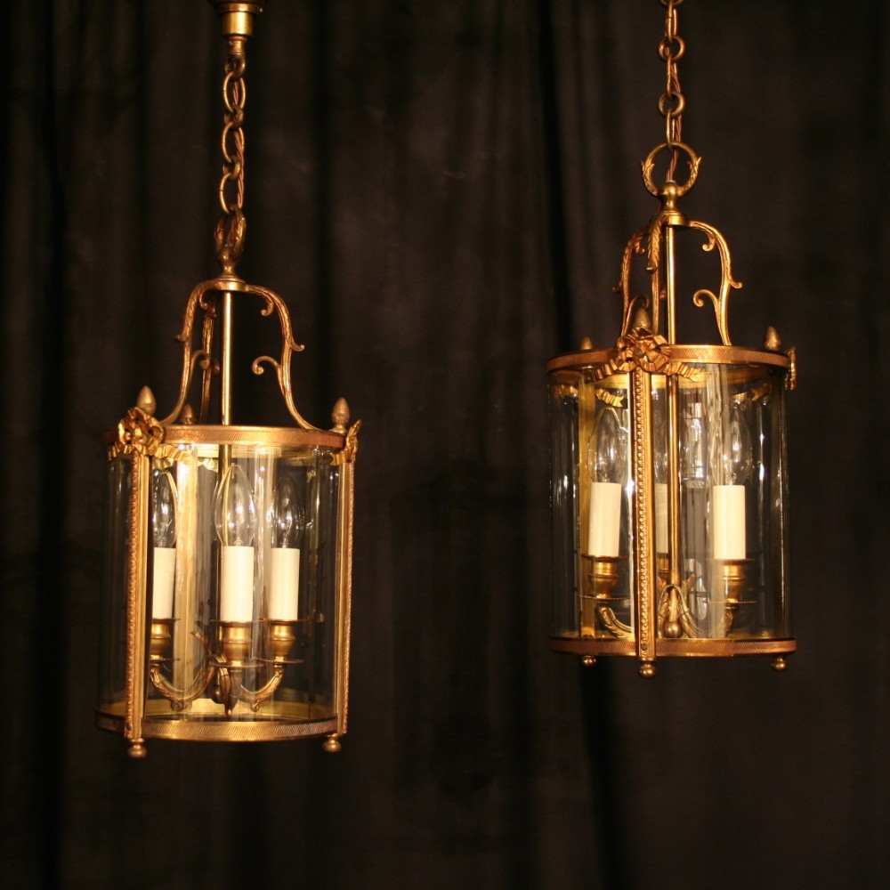 A French Pair Of Gilded Bronze Triple Light Convex Hall Lanterns