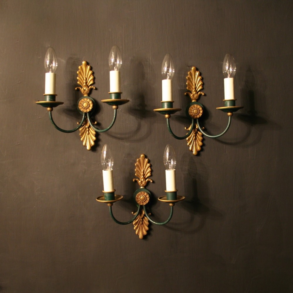 A French Set Of Three Empire Gilded Twin Arm Wall Lights