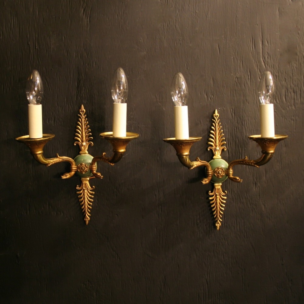 A French Pair Of Empire Gilded Twin Arm Wall Lights
