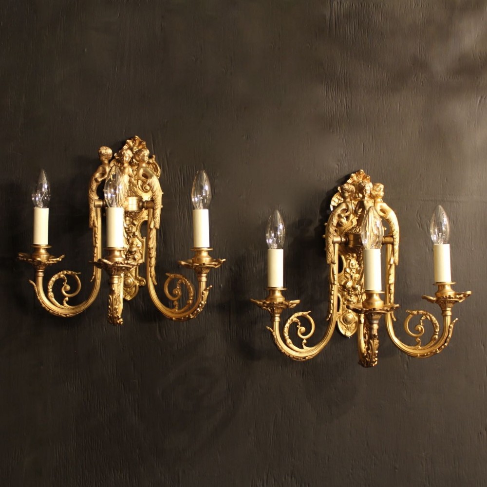 A French Pair Of Triple Arm Cherub Wall Lights