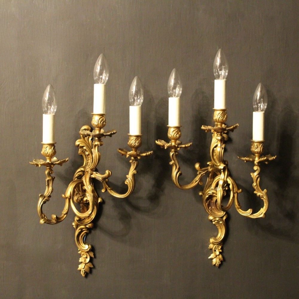 A French Pair Of Gilded Triple Arm Wall Lights