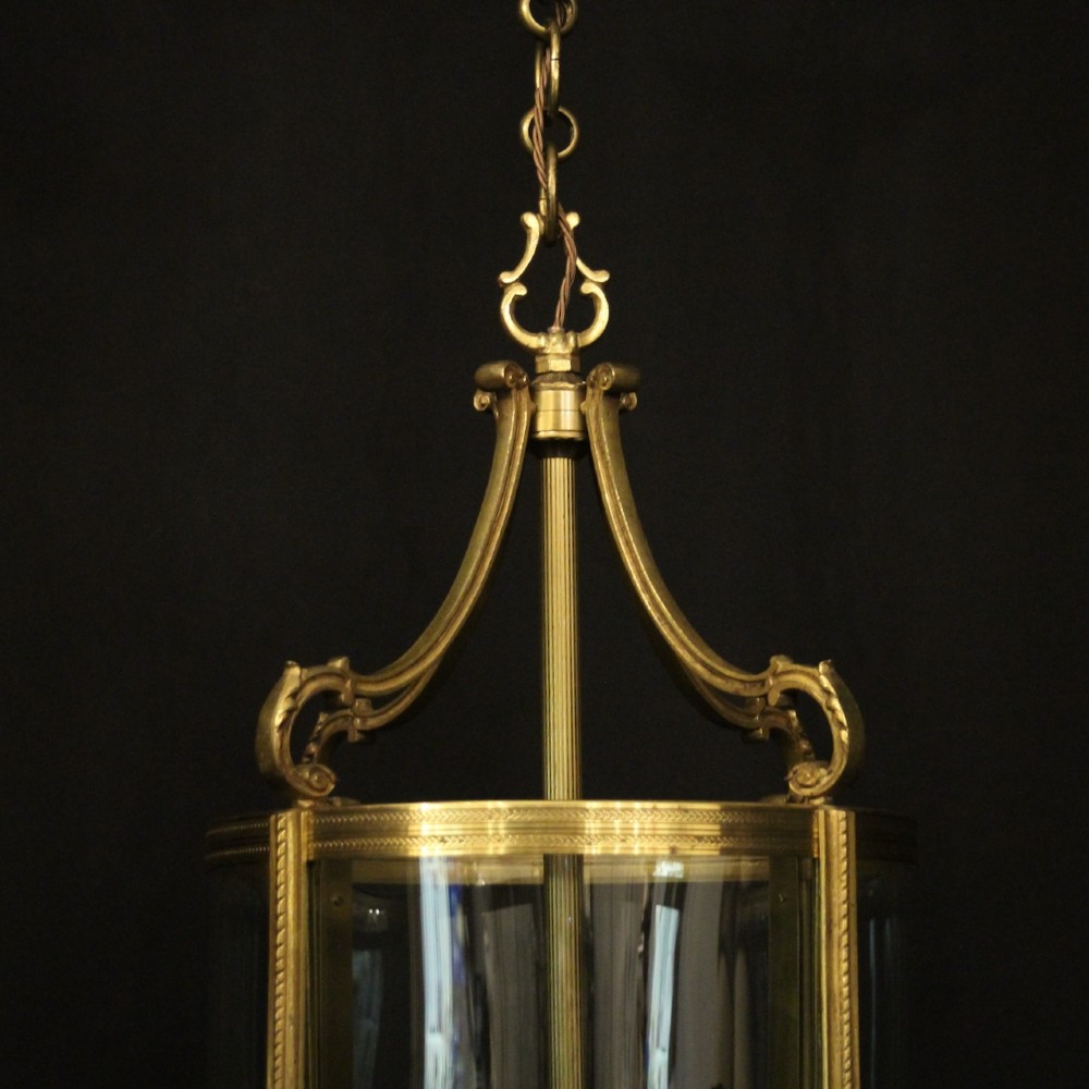A French gilt bronze cylindrical hall lantern with curved glass panels and internal candle sockets. View III