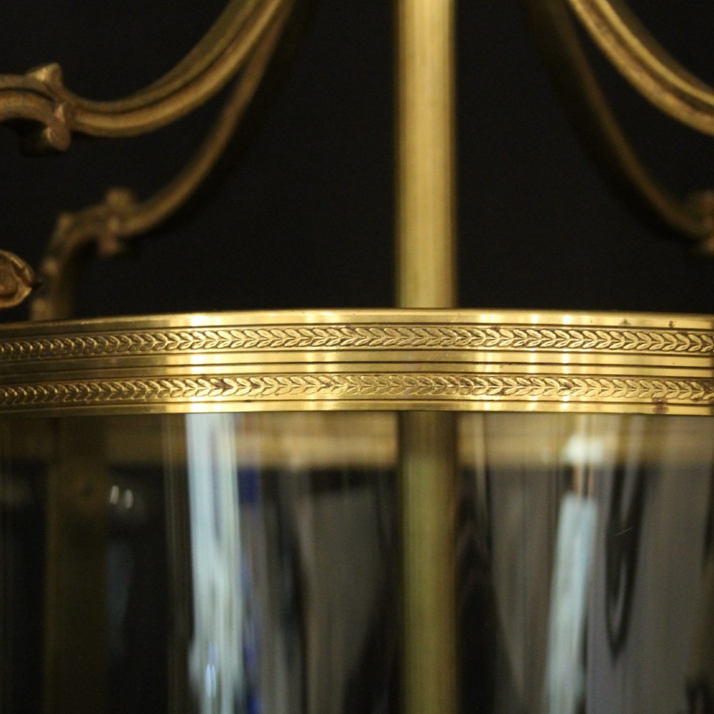 A French gilt bronze cylindrical hall lantern with curved glass panels and internal candle sockets. View VIII