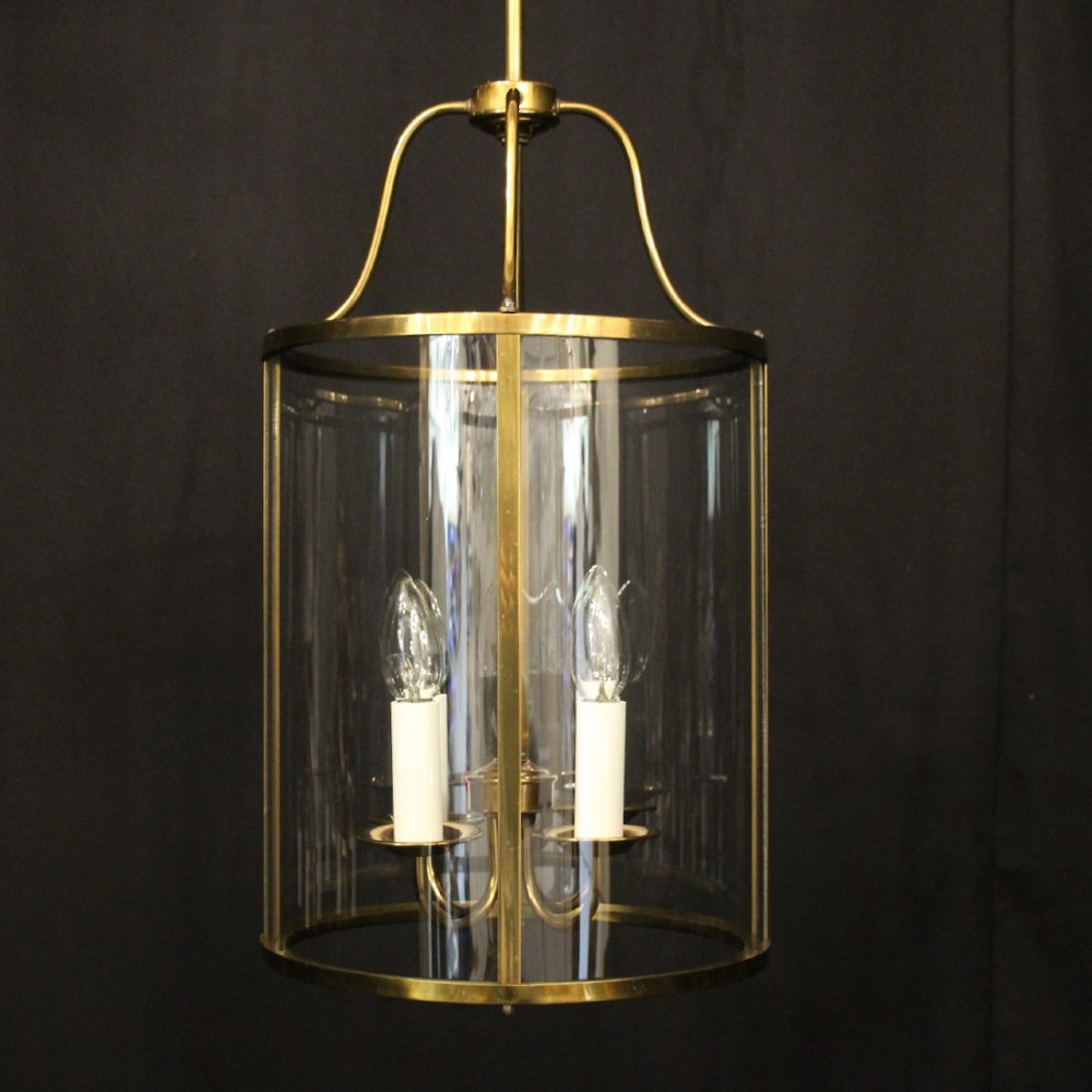 A cylindrical gilded brass hall lantern featuring curved convex glass panels and an internal four-light cluster. View II