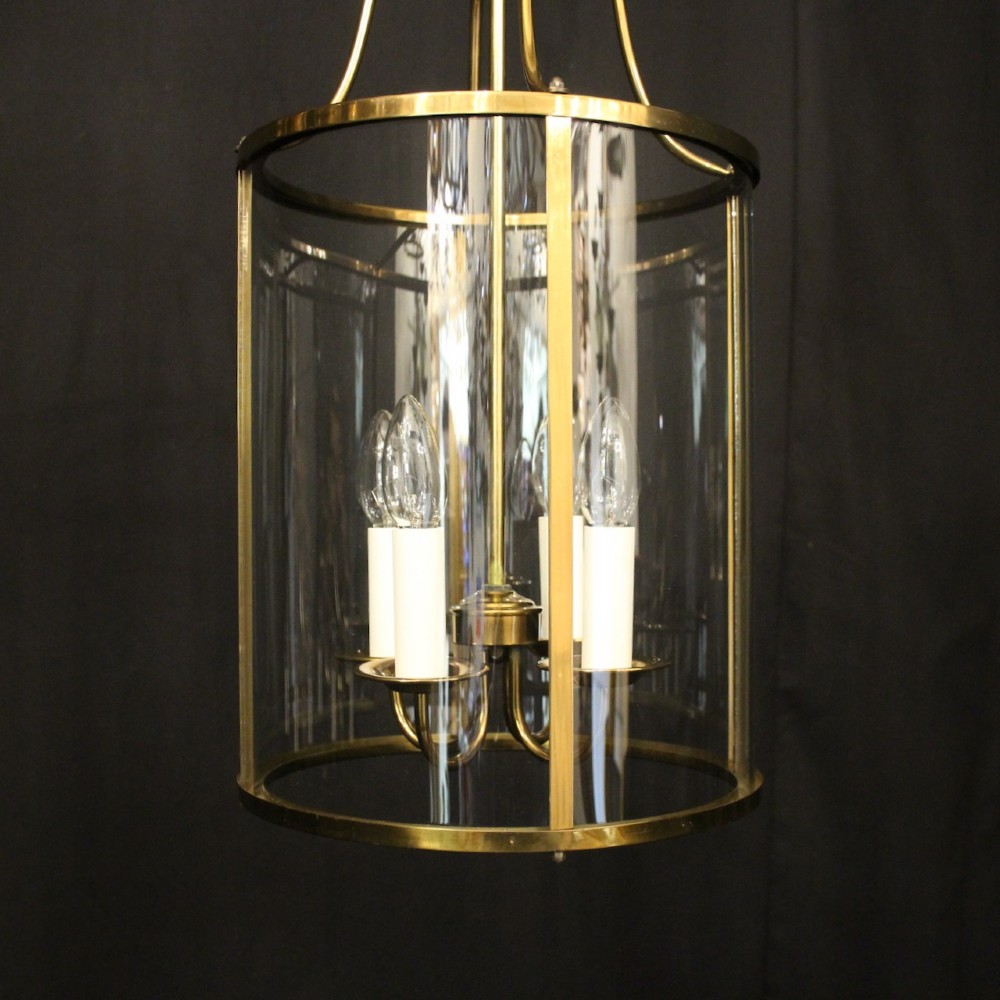 A cylindrical gilded brass hall lantern featuring curved convex glass panels and an internal four-light cluster. View III