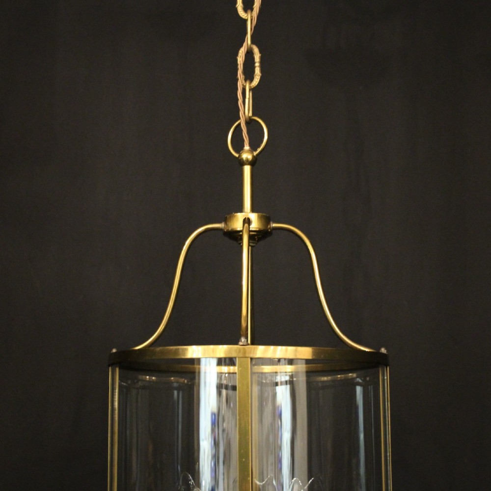 A cylindrical gilded brass hall lantern featuring curved convex glass panels and an internal four-light cluster. View IV