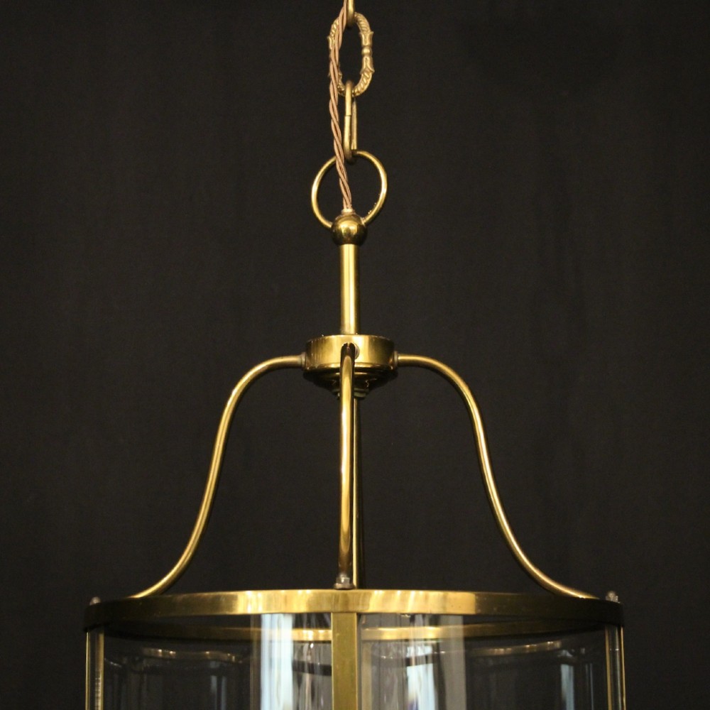 A cylindrical gilded brass hall lantern featuring curved convex glass panels and an internal four-light cluster. View V