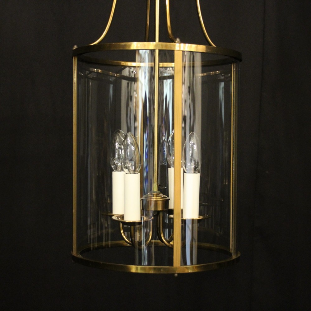 A cylindrical gilded brass hall lantern featuring curved convex glass panels and an internal four-light cluster. View VI