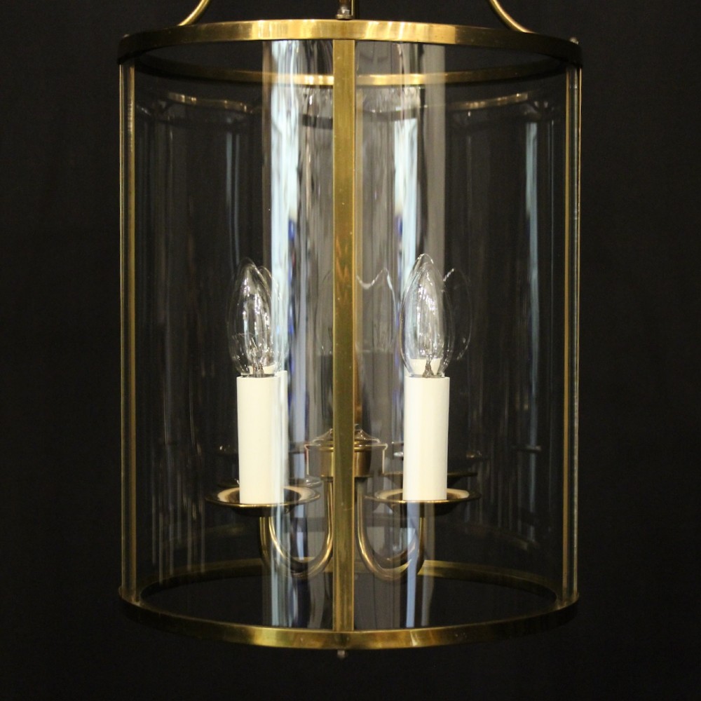 A cylindrical gilded brass hall lantern featuring curved convex glass panels and an internal four-light cluster. View VII