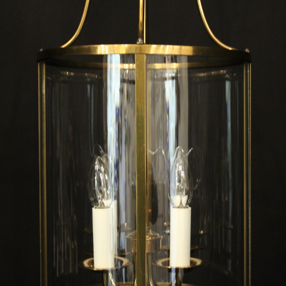A cylindrical gilded brass hall lantern featuring curved convex glass panels and an internal four-light cluster. View VIII