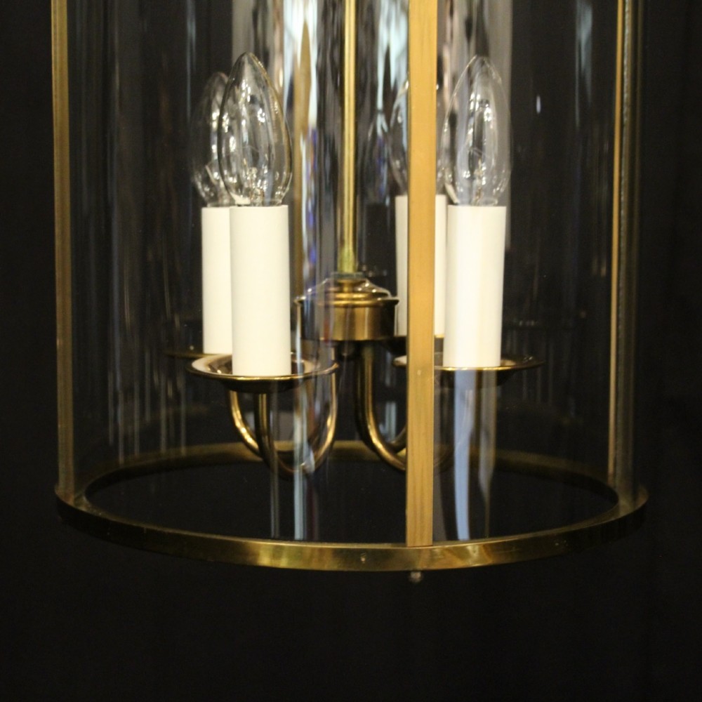 A cylindrical gilded brass hall lantern featuring curved convex glass panels and an internal four-light cluster. View IX