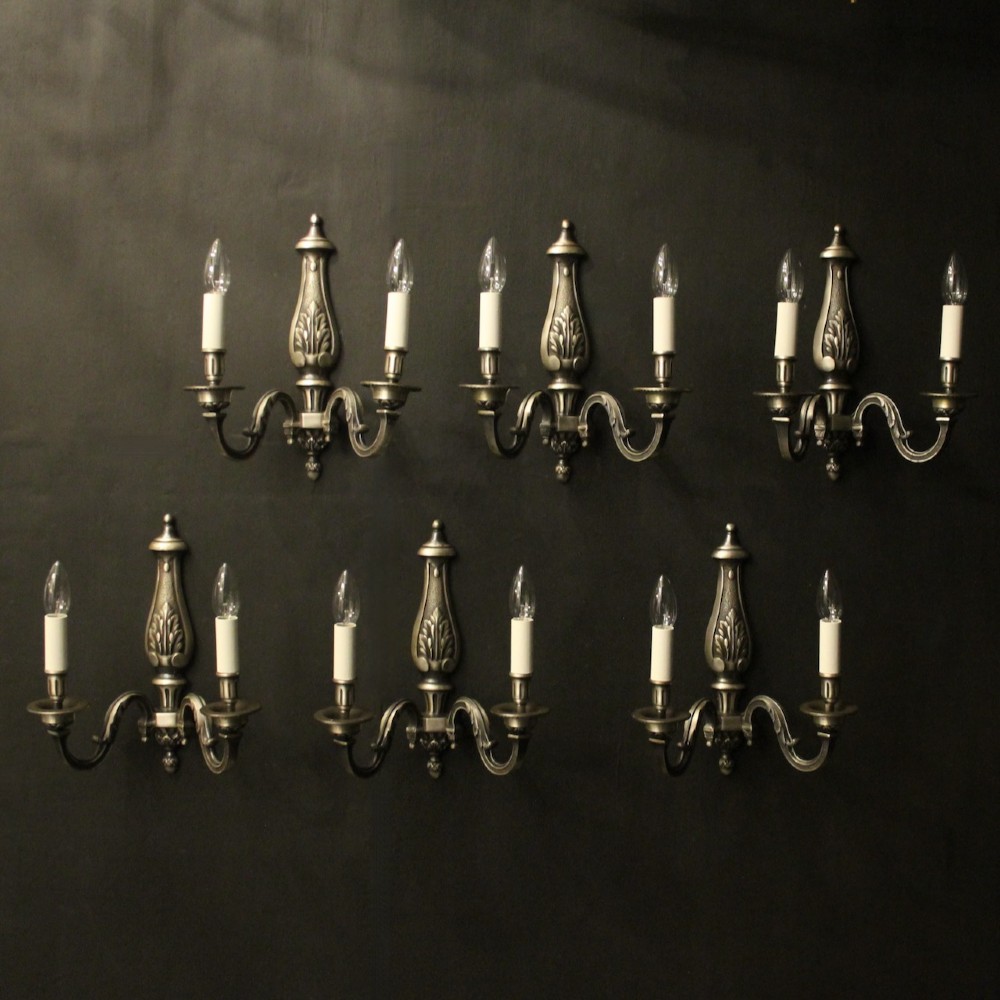 A set of six French twin-branch wall lights crafted from silver gilded metal with central acanthus backplates.