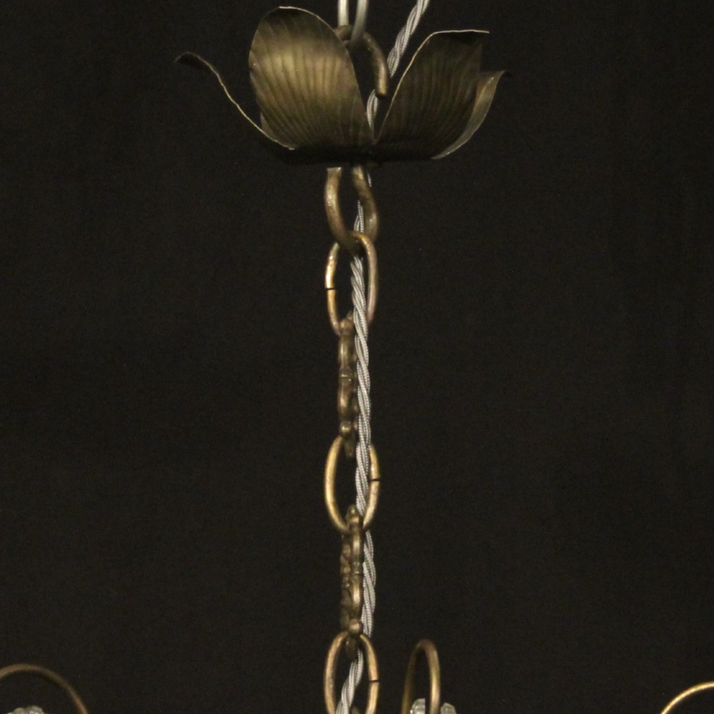An Italian multi-tiered chandelier featuring a patinated silvered frame adorned with hanging cut-crystal drops, faceted pendants, and six candle-effect light fittings. View X